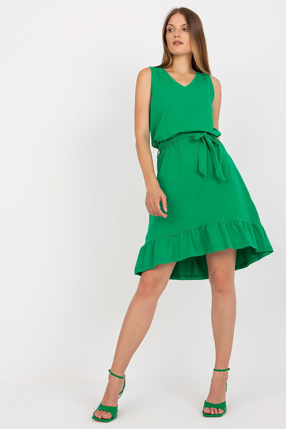 Charming model wearing the Elegant Asymmetrical Flared Summer Dress with Ruffle & Sweetheart Neckline by Rue Paris in vibrant green, displaying a fitted bodice and elegant flared skirt.