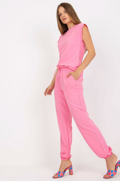 Elegant Rue Paris Summer Set showcasing a model in pink attire, highlighting the refined blouse and casual long pants with stylish pockets, perfect for summer outings.