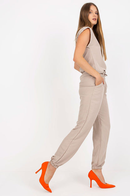 Side view of the Elegant Rue Paris Summer Set in beige, highlighting the luxurious fabric blend and elegant design, paired with striking orange heels.