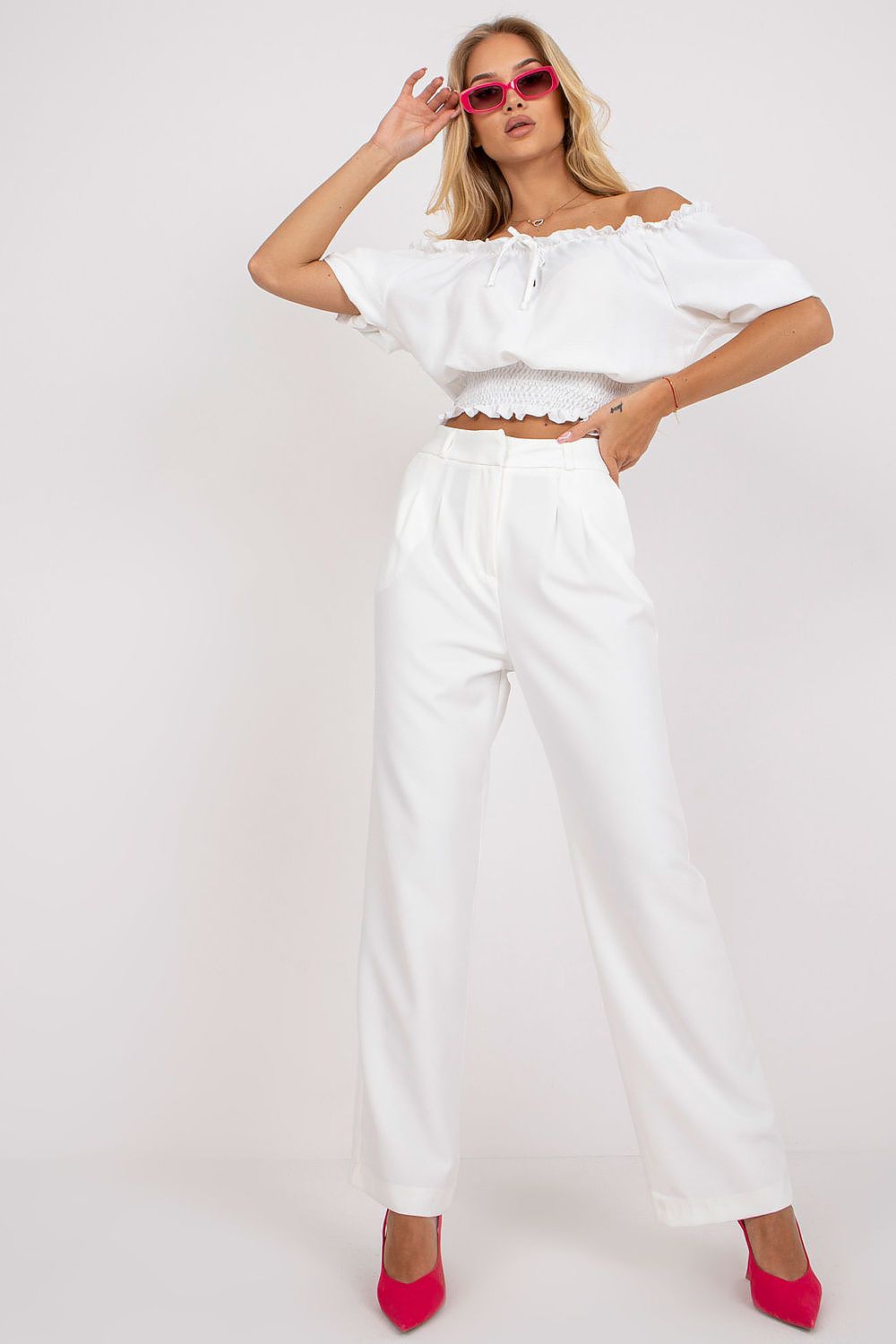 Model wearing Luxurious Wide Leg Women’s Trousers by Rue Paris, paired with an elegant white cropped top and striking pink heels, embodying sophistication and style.