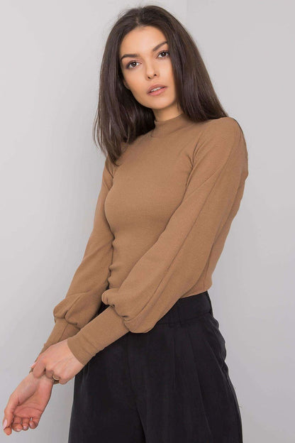 Model showcasing the Elegant Long Sleeve Ribbed Blouse by Rue Paris in a rich brown hue, crafted from luxurious cotton and spandex fabric, featuring wide ribbed cuffs for a sophisticated touch.