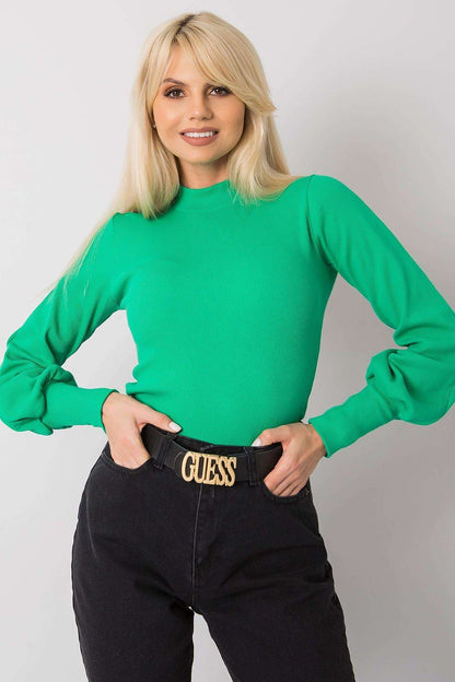 Beautiful blonde model wearing the Elegant Long Sleeve Ribbed Blouse by Rue Paris in vibrant green, highlighting its luxurious cotton and spandex construction and wide ribbed cuffs.