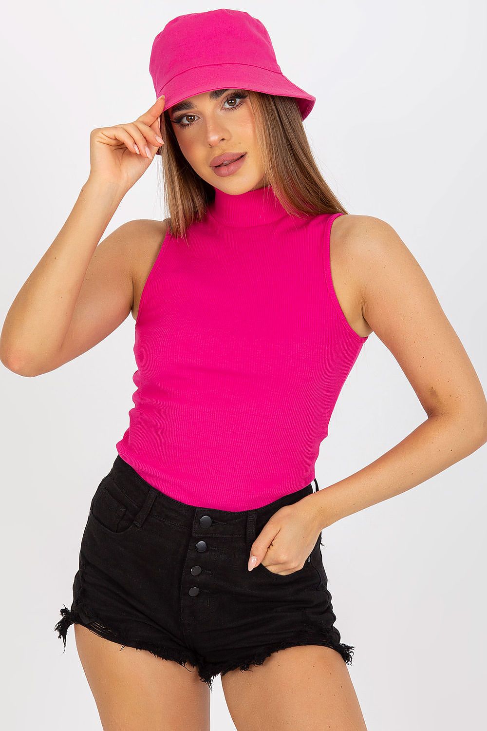 Elegant Ribbed Half Turtleneck Top by Rue Paris, showcased in vibrant pink, paired with stylish black denim shorts. The model exudes sophistication with a chic bucket hat.