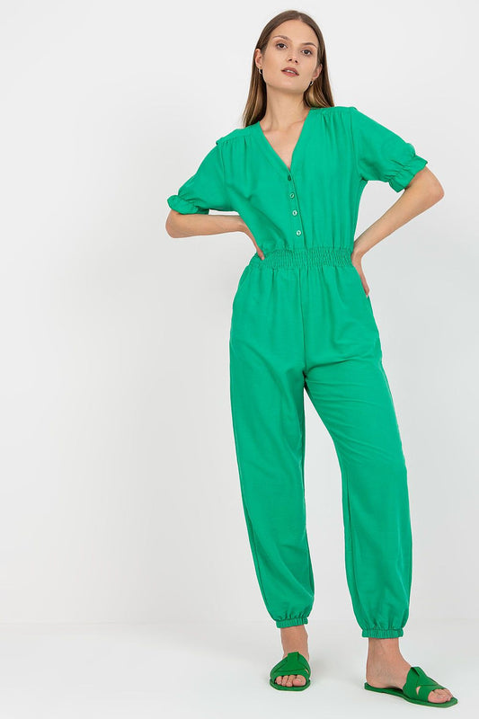 Rue Paris Summer Cotton Jumpsuit with Frill Sleeves and Side Pockets - A model showcasing a luxurious green jumpsuit with short frill sleeves and button closure, perfect for summer elegance.