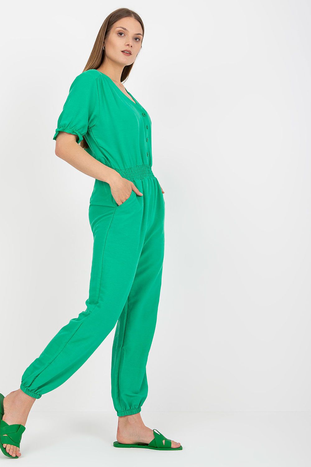 Rue Paris Summer Cotton Jumpsuit with Frill Sleeves and Side Pockets - Stylish model wearing a green jumpsuit with frill sleeves, exuding comfort and class for warm summer days.