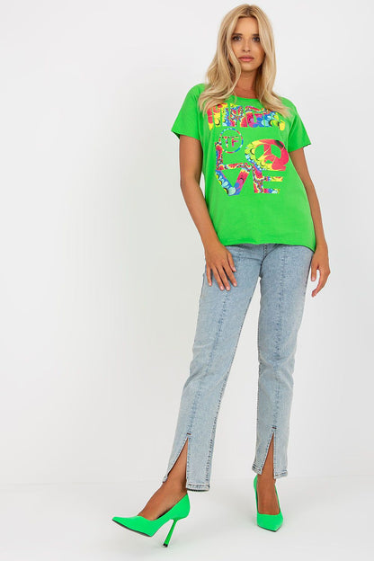 Model wearing an Elegant Straight Cut Cotton Spandex Blouse with Decorative Print – Short Sleeves, EU Size 0, paired with light blue jeans and vibrant green high heels, exuding a chic luxury style.
