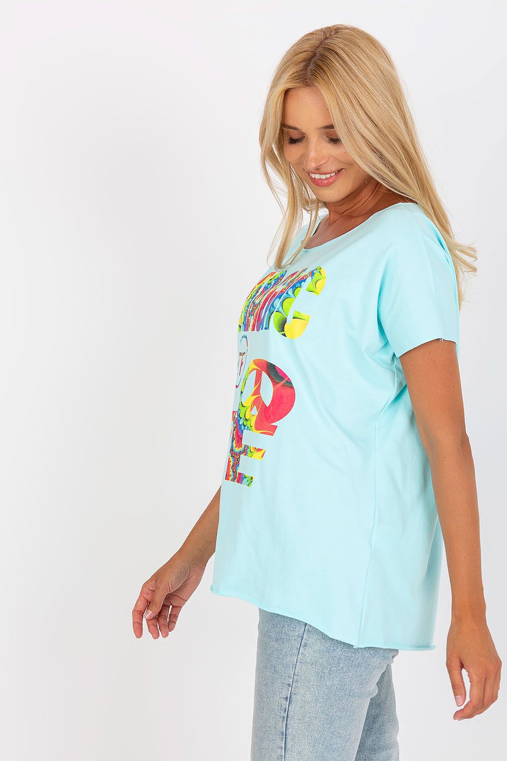 Elegant Straight Cut Cotton Spandex Blouse with Decorative Print – Short Sleeves, EU Size 0, side view of the model wearing the light blue blouse, showcasing its contemporary style and playful print.