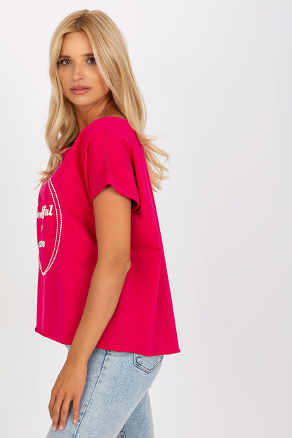Side view of a model wearing the Elegant Short-Sleeved Blouse with Embroidery in pink, highlighting the loose fit and sophisticated style.