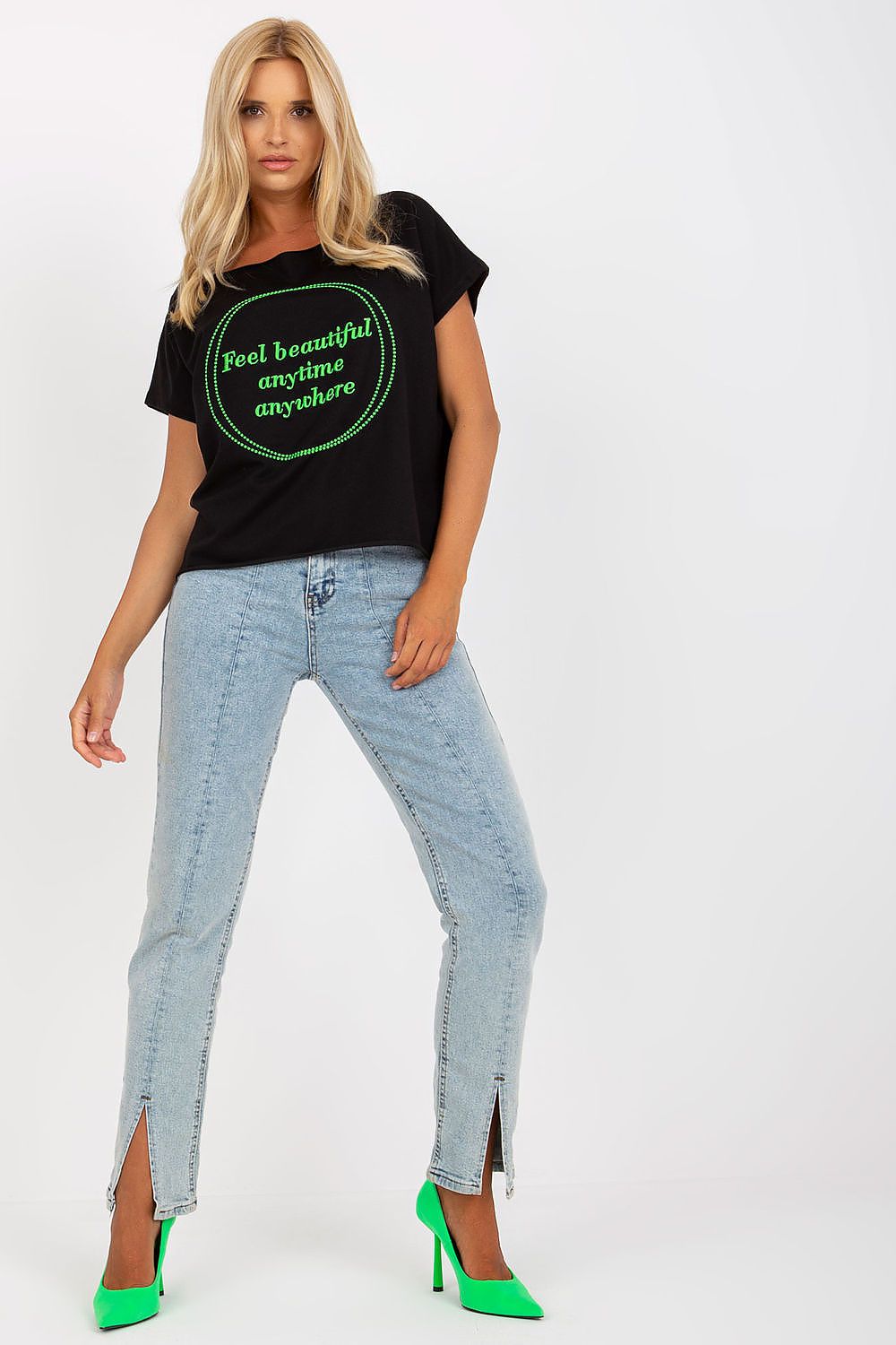 Model posing in a black Elegant Short-Sleeved Blouse with Embroidery, accentuated with stylish green heels, exuding elegance and confidence.