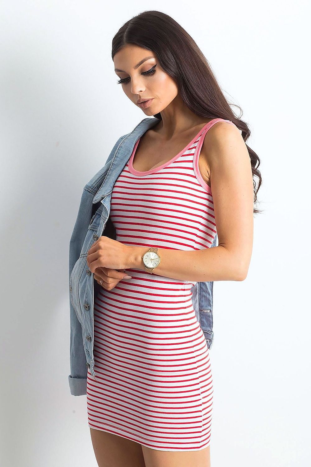 Elegant Summer Strapless Striped Mini Dress by Yups styled with a casual denim jacket, model showcasing the fitted design in a red striped pattern.
