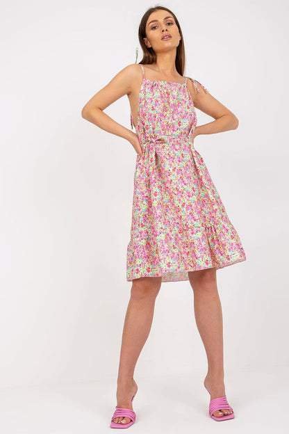 Elegant Summer Dress by Rue Paris with Colorful Pattern, Tied Straps, and Flattering Ruffles, model striking a pose, showcasing the vibrant floral design and flattering silhouette.