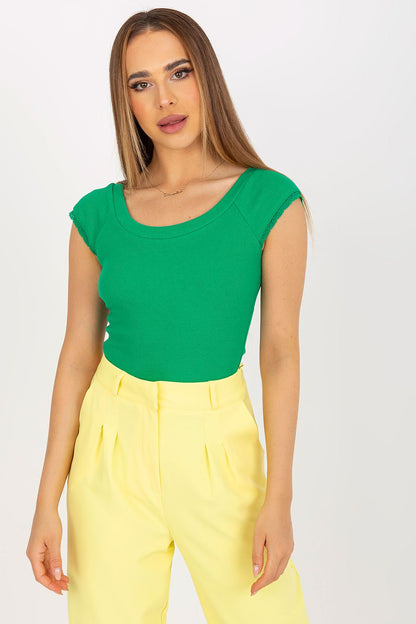 Elegant Fitted Lace-Trimmed Blouse With Boat Neckline by Rue Paris, showcased on a model in a vibrant green outfit paired with elegant yellow trousers, exuding sophistication.