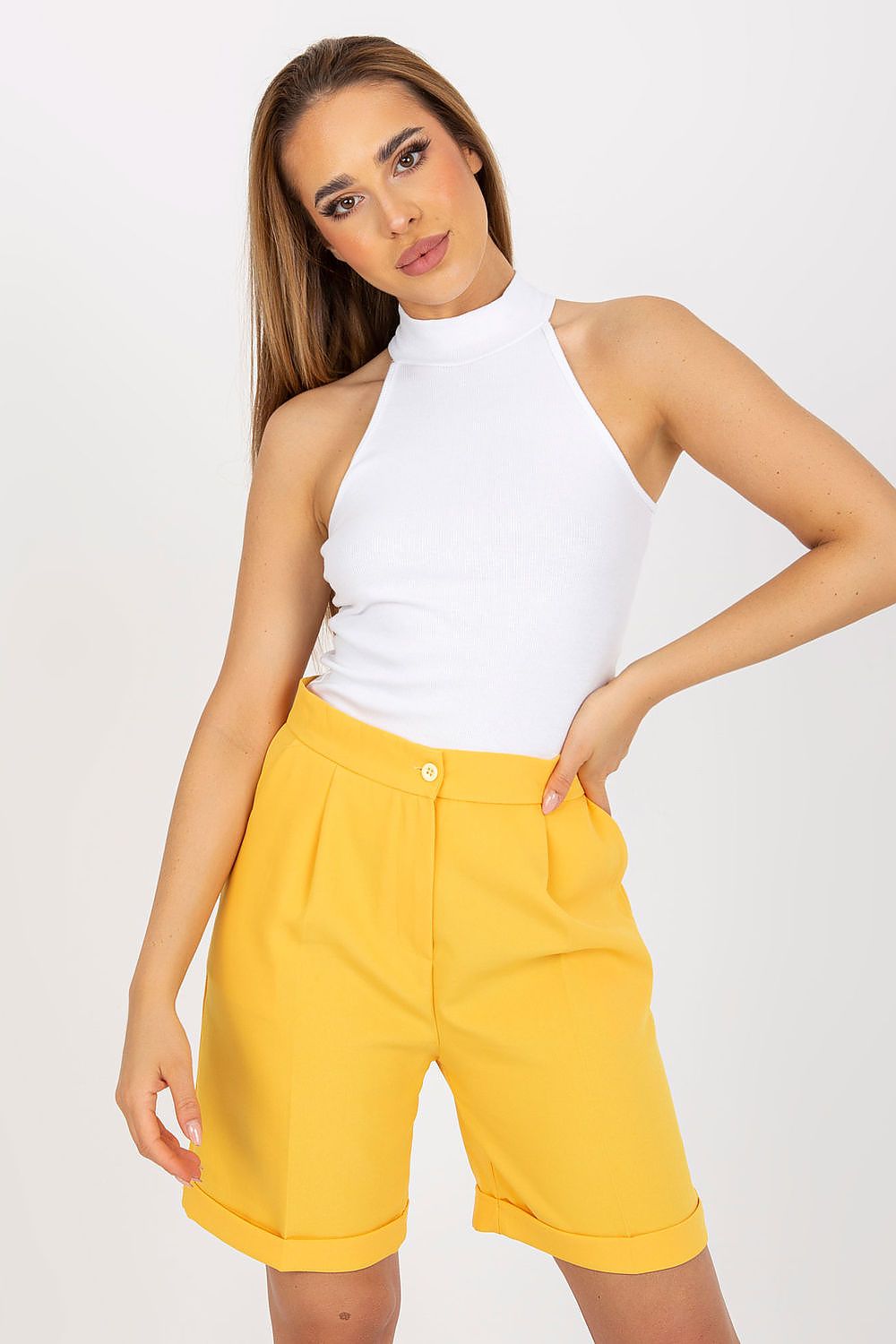 Elegant model wearing a Half Turtleneck Ribbed Top by Rue Paris in a stylish white colour, paired with vibrant yellow shorts, showcasing effortless luxury and contemporary fashion.