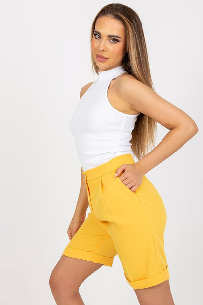 Half Turtleneck Ribbed Top by Rue Paris paired with tailored yellow shorts, accentuating chic and elegant fashion in a modern aesthetic.