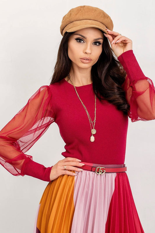Elegant Rue Paris Visionary Blouse with Long Transparent Sleeves - Cotton and Spandex Blend, model showcasing a stunning red blouse with flowing sheer sleeves, styled with a fashionable pleated skirt and chic accessories.