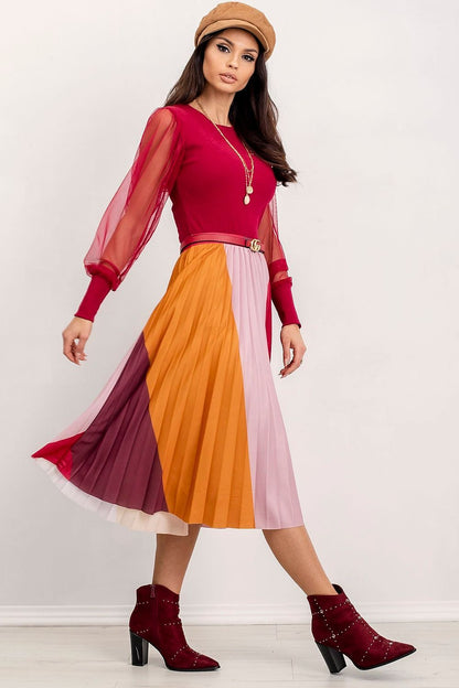 Elegant Rue Paris Visionary Blouse with Long Transparent Sleeves - Cotton and Spandex Blend, model in a dynamic pose wearing a luxurious red blouse featuring transparent sleeves, paired with an elegantly pleated skirt.