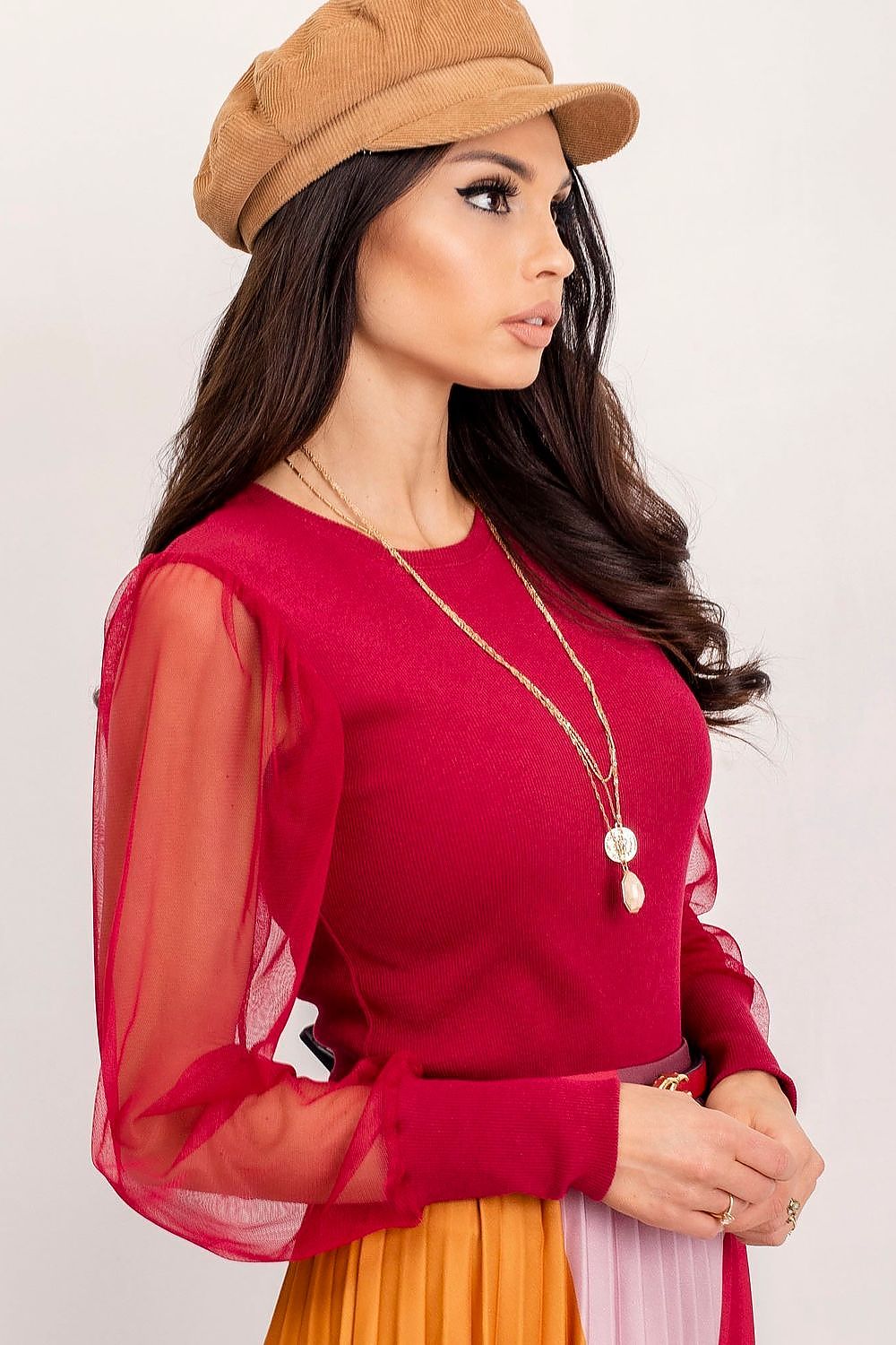 Elegant Rue Paris Visionary Blouse with Long Transparent Sleeves - Cotton and Spandex Blend, close-up view of the model displaying the intricate design of the red blouse with transparent sleeves and stylish accessories.