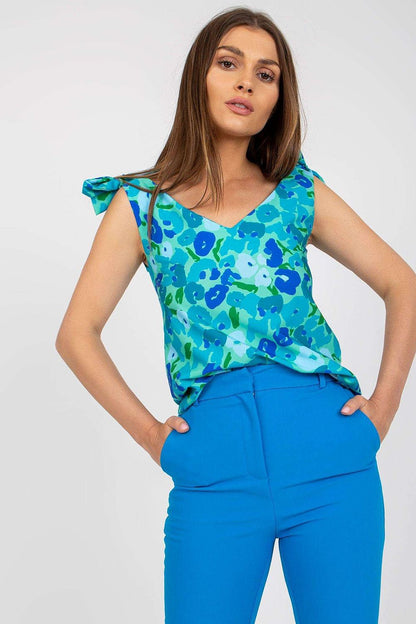 Elegant Heart Neckline Top with Decorative Ties in 100% Polyester by Rue Paris, adorned in chic blue floral patterns, paired tastefully with vibrant blue trousers.
