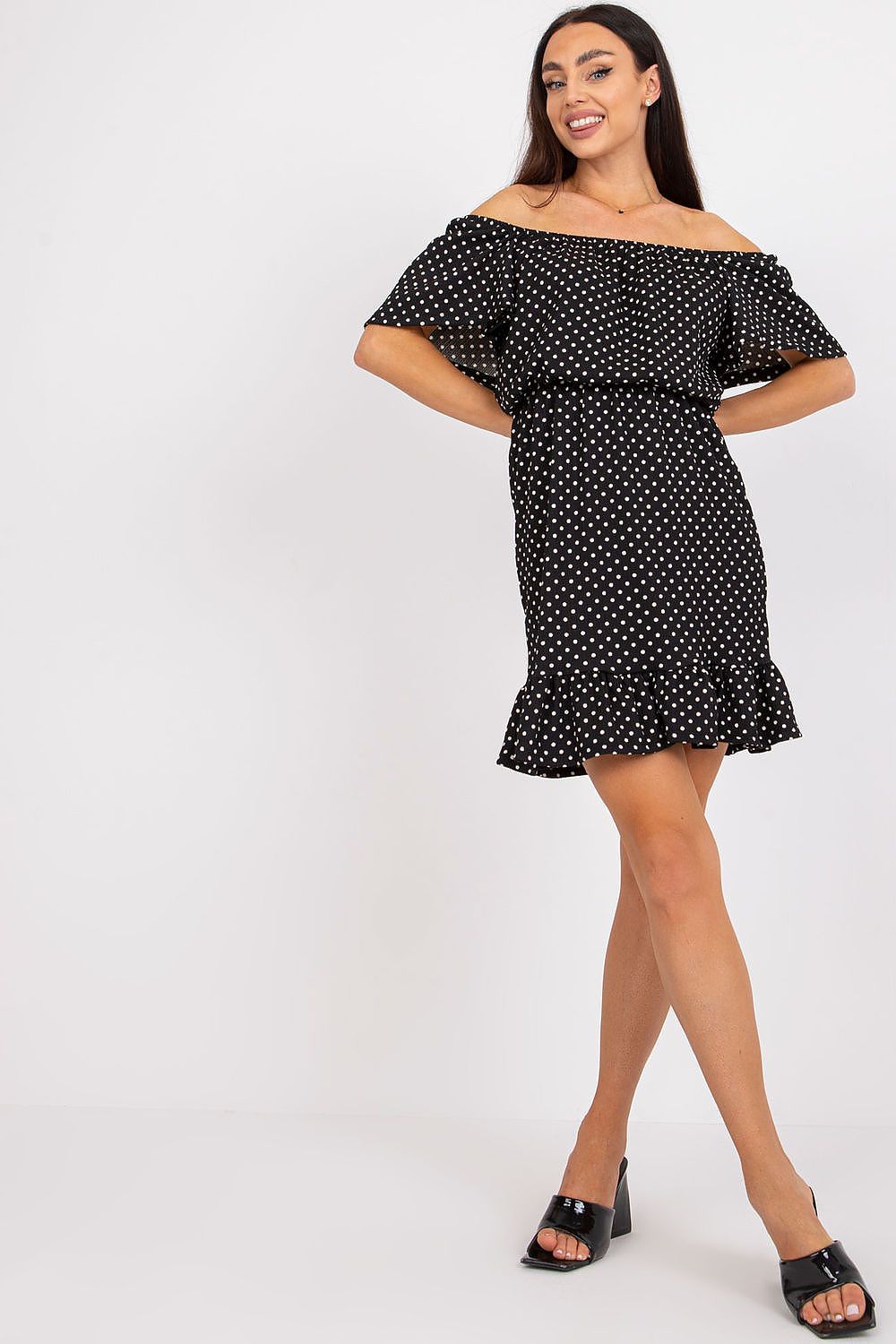 Luxury Cotton Ruffle Dress with Spanish Neckline by Rue Paris – Elegant Summer Daydress worn by a model, showcasing the off-shoulder ruffles and polka dot design.