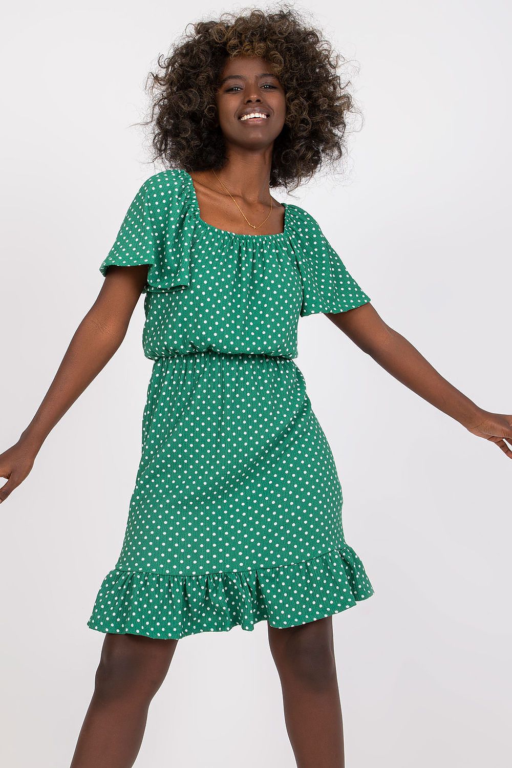 Luxury Cotton Ruffle Dress with Spanish Neckline by Rue Paris – Elegant Summer Daydress styled on a model with curly hair, showcasing the green colour and glamorous ruffle details.