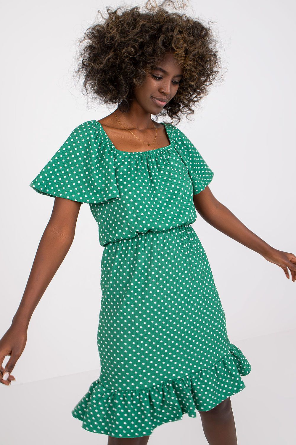 Luxury Cotton Ruffle Dress with Spanish Neckline by Rue Paris displayed on a model, featuring short sleeves and a playful ruffle hem in vibrant green with white polka dots, perfect for an elegant summer day.