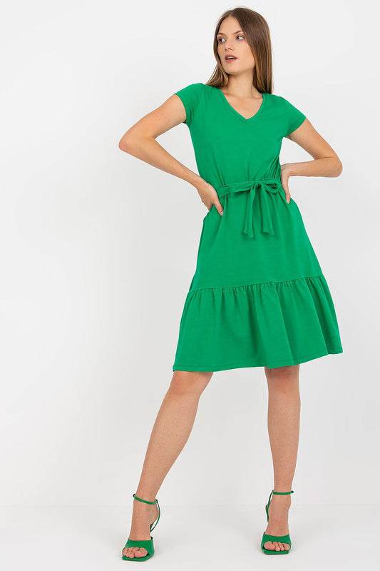 Elegant Summer Dress by Rue Paris - Flared Cut, V-Neckline, Waist Tie, Ruffled Hem, showcased on a model wearing a vibrant green dress with short sleeves and a cinched waist.