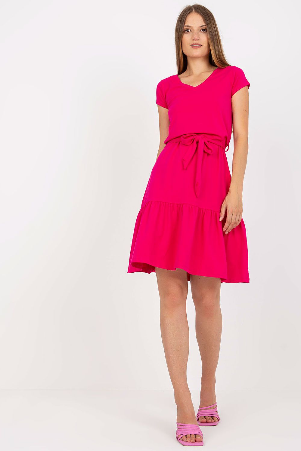Elegant Summer Dress by Rue Paris featuring a vibrant pink flared cut, v-neckline, waist tie, and ruffled hem, showcased on a model.