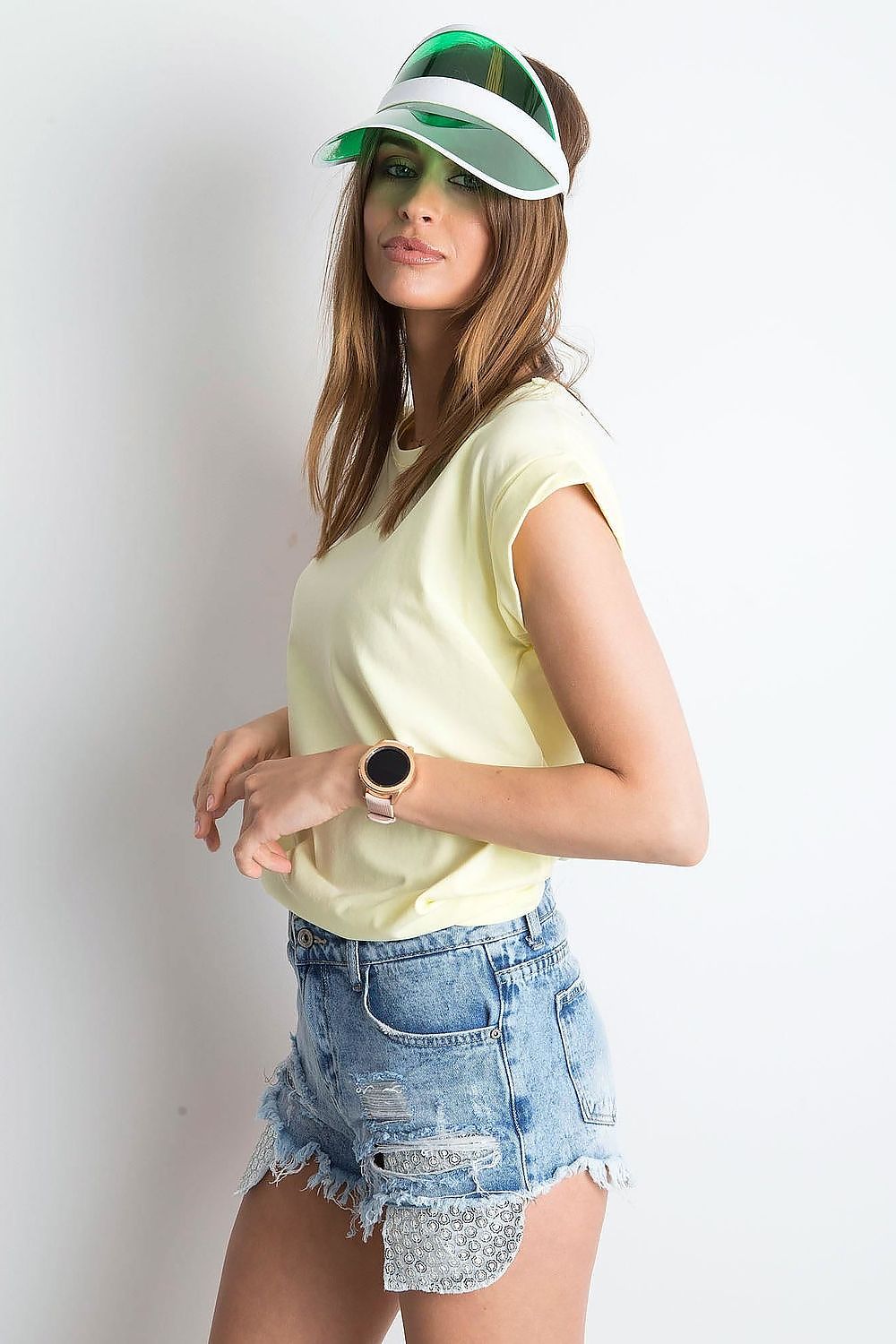 Side view of the Women's Luxurious BFG Cotton Spandex T-Shirt in pale yellow, paired with distressed denim shorts, highlighting a chic casual look.