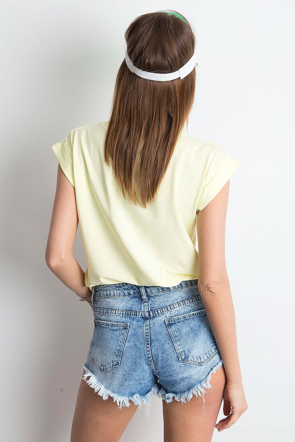 Back view of the Women's Luxurious BFG Cotton Spandex T-Shirt in pale yellow, showcasing a relaxed fit with denim shorts, perfect for a stylish summer day.
