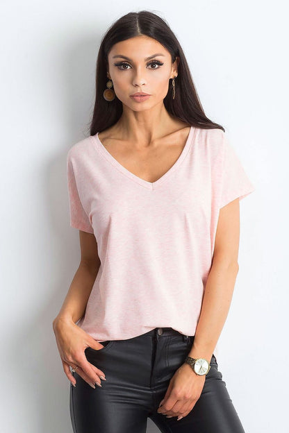 Elegant Women's Short Sleeve T-Shirt with Heart Neckline in soft pink, exuding luxury and style, paired with sleek black leather trousers.