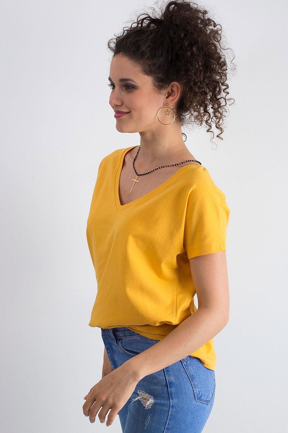 Elegant Women's Short Sleeve T-Shirt with Heart Neckline elegantly styled, worn in yellow fabric, perfect for casual occasions.