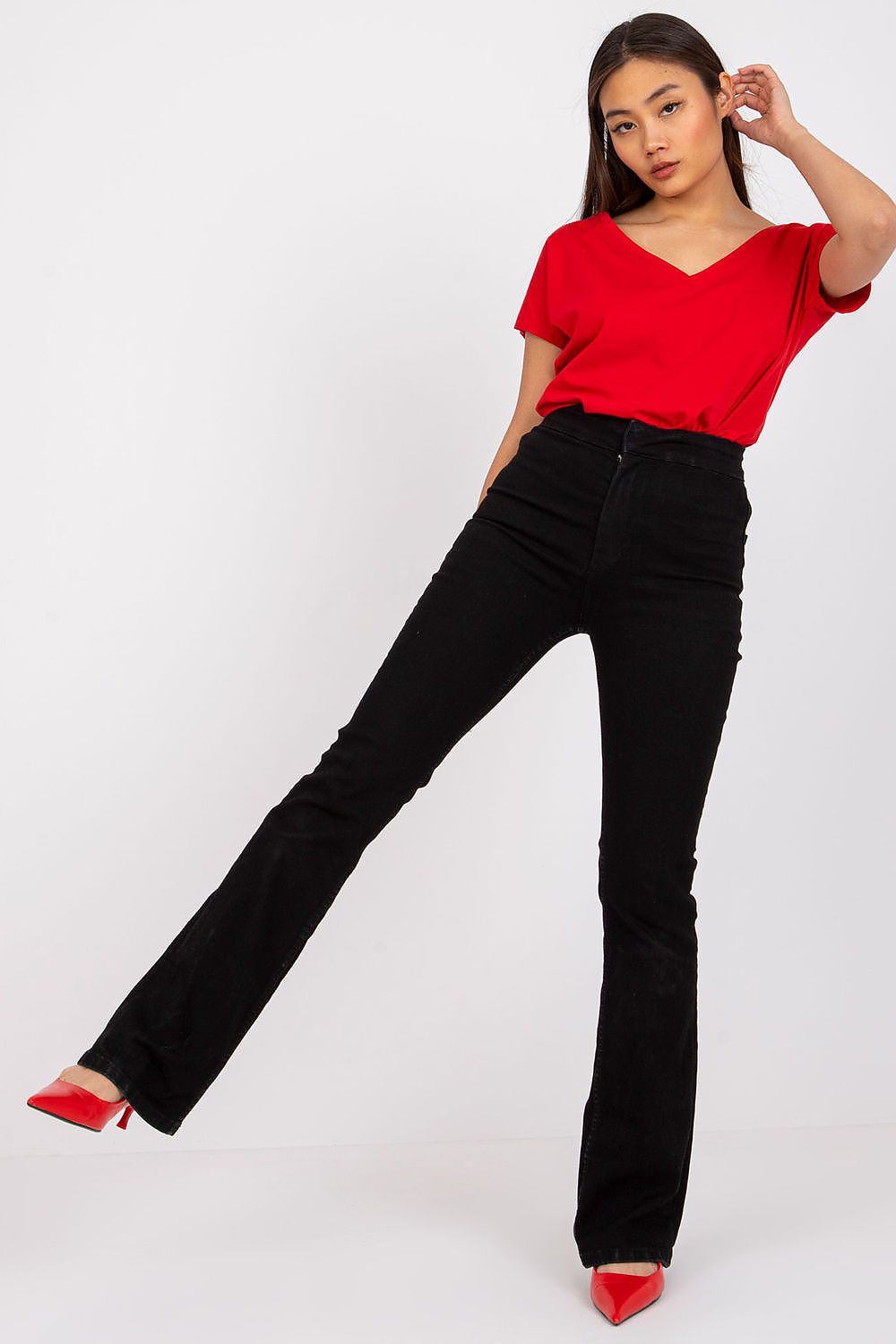 Model wearing the Elegant Women's Short Sleeve T-Shirt with Heart Neckline in red, elegantly paired with flared black trousers for a chic style.