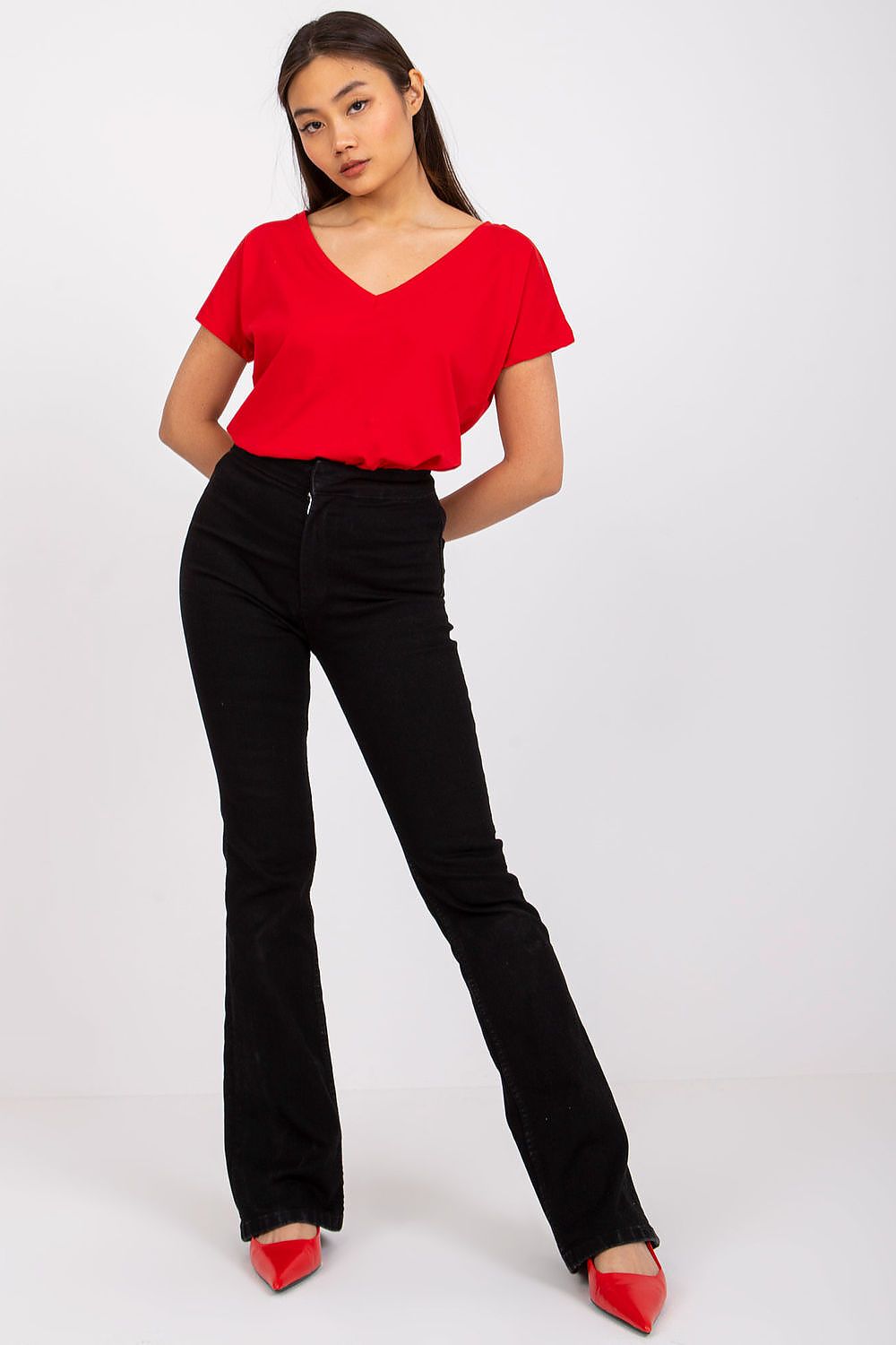 Front view of a model in the Elegant Women's Short Sleeve T-Shirt with Heart Neckline in red, stylishly combined with black flared pants.