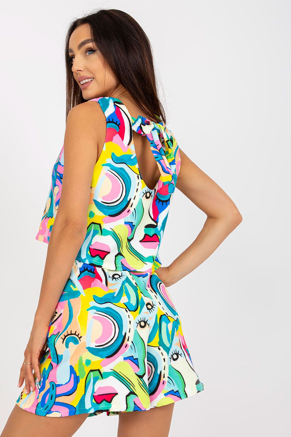 Stylish woman showcasing the Italy Moda Summer Two-Piece Set, featuring a loose cut top and wide leg shorts in vibrant, artistic patterns, perfect for stylish occasions.