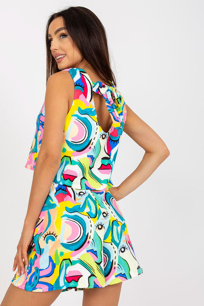 Stylish woman showcasing the Italy Moda Summer Two-Piece Set, featuring a loose cut top and wide leg shorts in vibrant, artistic patterns, perfect for stylish occasions.