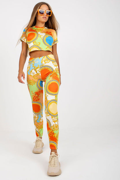 Women’s Luxury High-Rise Trousers with Elastic Waist and Pockets by Italy Moda, featuring vibrant and intricate colourful patterns, model showcasing the complete outfit paired with stylish sunglasses.