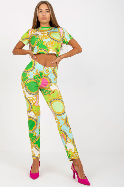 Elegant woman flaunting Italy Moda’s luxury high-rise trousers with an elastic waist and pockets, adorned in vibrant green, blue, and pink patterns, complemented by fashionable pink heels.