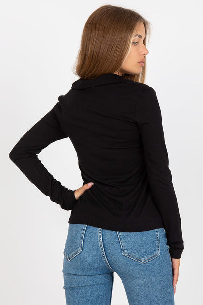 Back view of the Elegant Women's Long Sleeve Cotton Button-Down Shirt by Rue Paris in black, highlighting its fitted silhouette, styled with blue denim trousers.