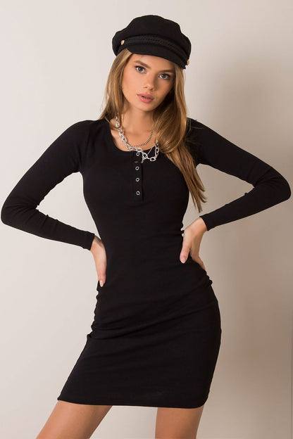 Luxurious Fitted Ribbed Dress with Long Sleeves and Press Stud Fastening by Rue Paris, modelled in classic black with stylish accessories.