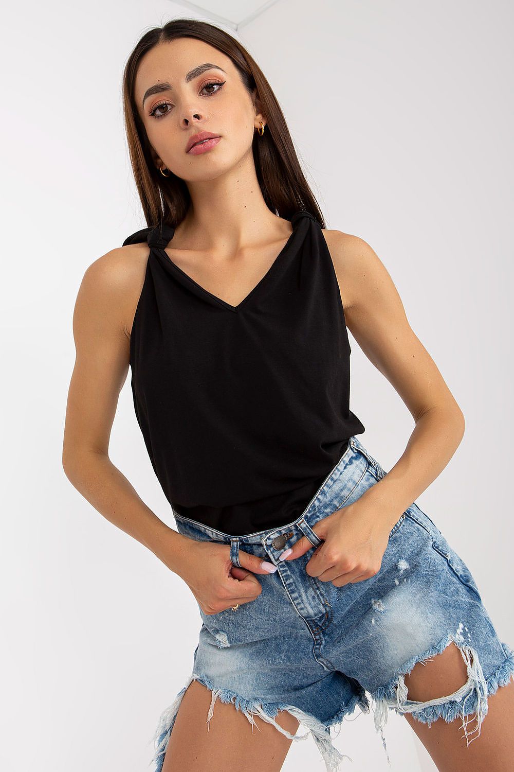 Luxury Strapless V-Neck Top With Ties For Women by Rue Paris, elegantly styled in black, paired with distressed denim shorts.