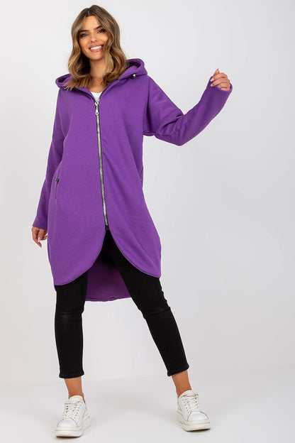 Elegant Rue Paris Zip-Up Extended Cut Sweatshirt with Hood and Side Pockets in vibrant purple, styled with black leggings and white sneakers, showcasing a luxurious blend of cotton and spandex for comfort and sophistication.