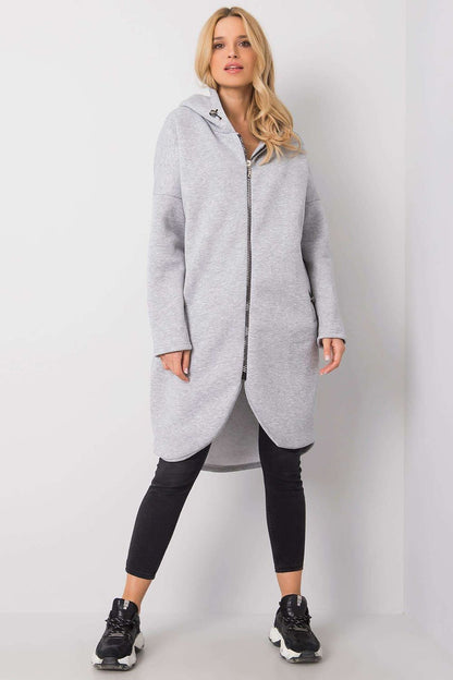 Rue Paris Zip-Up Extended Cut Sweatshirt with Hood and Side Pockets in grey, elegantly styled with long sleeves and a zippered front, complemented by sleek black leggings and stylish athletic shoes.