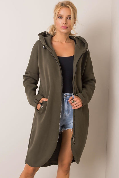 Rue Paris Zip-Up Extended Cut Sweatshirt with Hood and Side Pockets in olive green, beautifully paired with denim shorts for a sophisticated casual look.