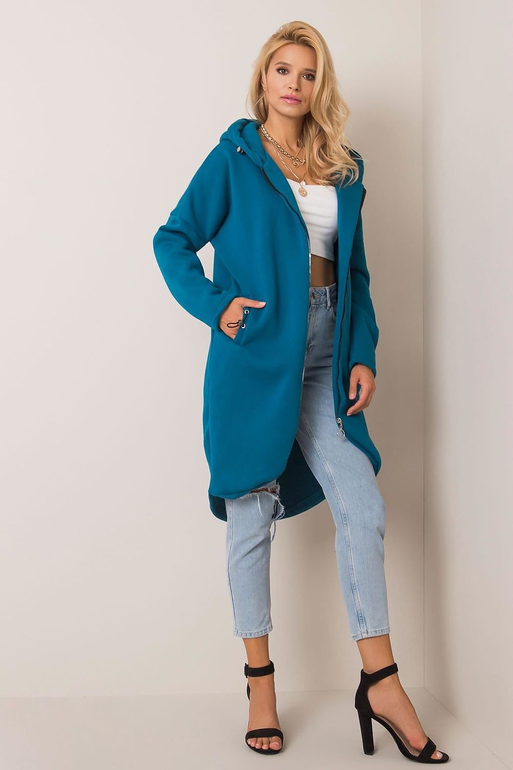 Rue Paris Zip-Up Extended Cut Sweatshirt with Hood and Side Pockets styled effortlessly by a model, exuding sophistication in bright ocean blue, perfect for refined leisurewear.