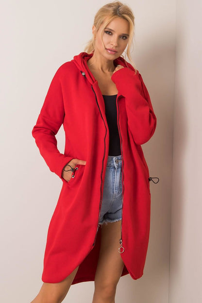 Front view of a fashionable model wearing the red Rue Paris Zip-Up Extended Cut Sweatshirt with Hood and Side Pockets, showcasing versatility and elegance for modern outfits.