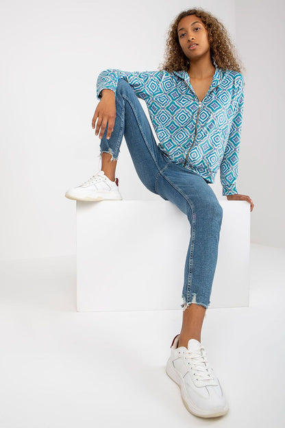 Elegant Rue Paris Women's Zippered Sweatshirt with Hood and Long Sleeves, beautifully displayed with fashionable blue jeans and trendy white sneakers, showcasing a stylish geometric pattern.