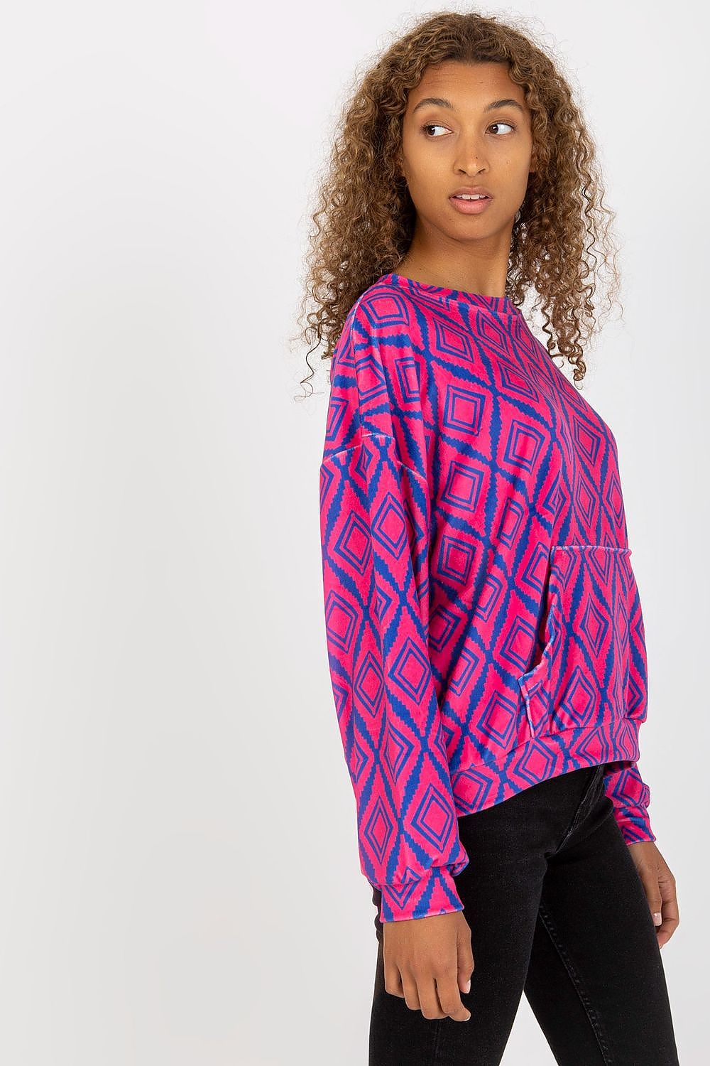 Side view of Rue Paris Women's Long Sleeve Sweatshirt with kangaroo pocket, highlighting its unique pattern and stylish silhouette worn by a fashionable model.