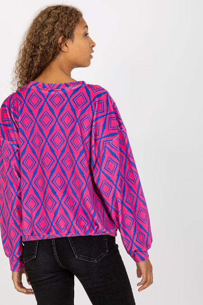 Back view of Rue Paris Women's Long Sleeve Sweatshirt, illustrating the trendy geometric design and relaxed fit, worn by an elegant model.