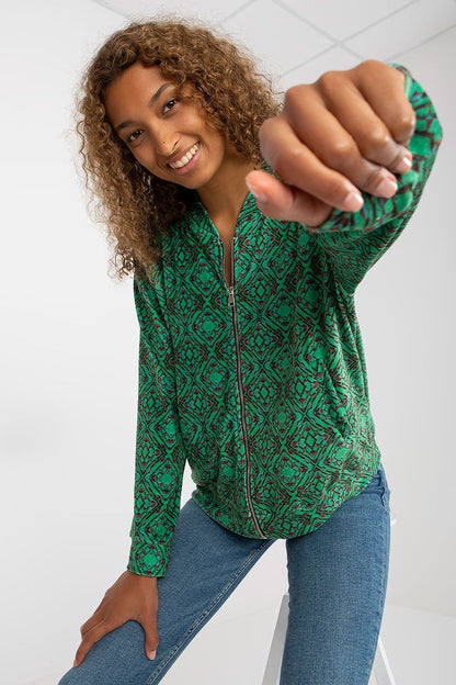 Luxury Women's Zip Sweatshirt by Rue Paris with Slip Pockets - A stylish model showcasing the vibrant green patterned sweatshirt, perfect for casual elegance.