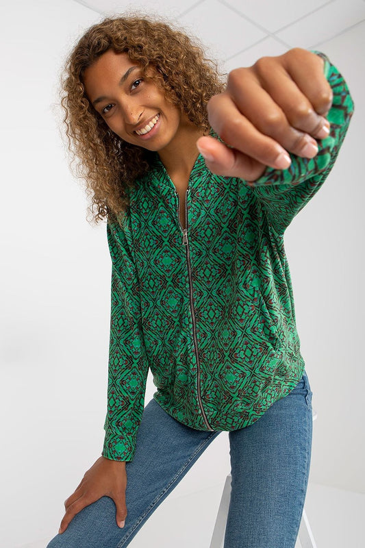 Luxury Women's Zip Sweatshirt by Rue Paris with Slip Pockets - A stylish model showcasing the vibrant green patterned sweatshirt, perfect for casual elegance.